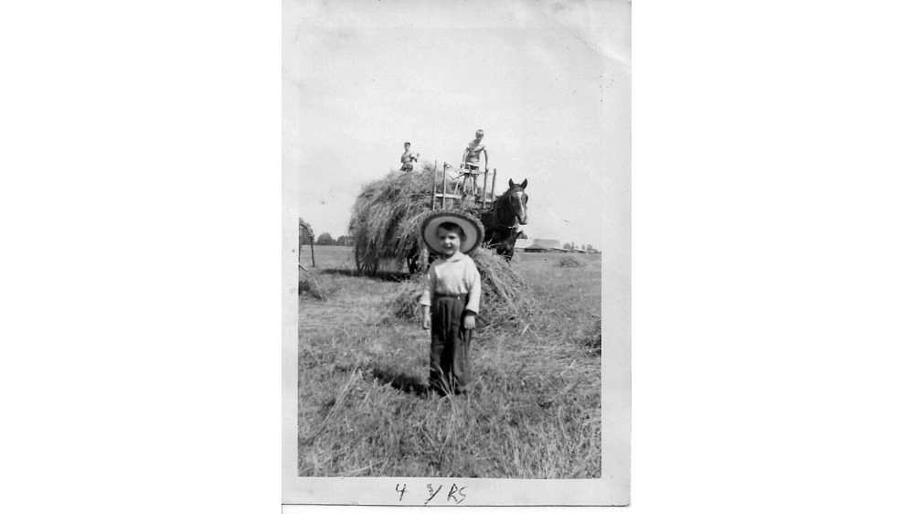 David Schwartzman in front of hay wagon (1952)
